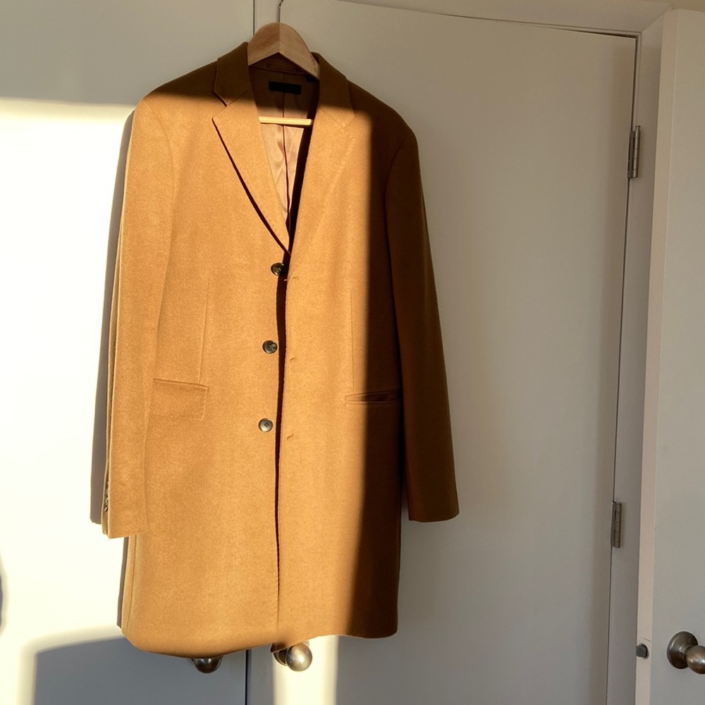 Uniqlo mid length camel topcoat with pique stitching.